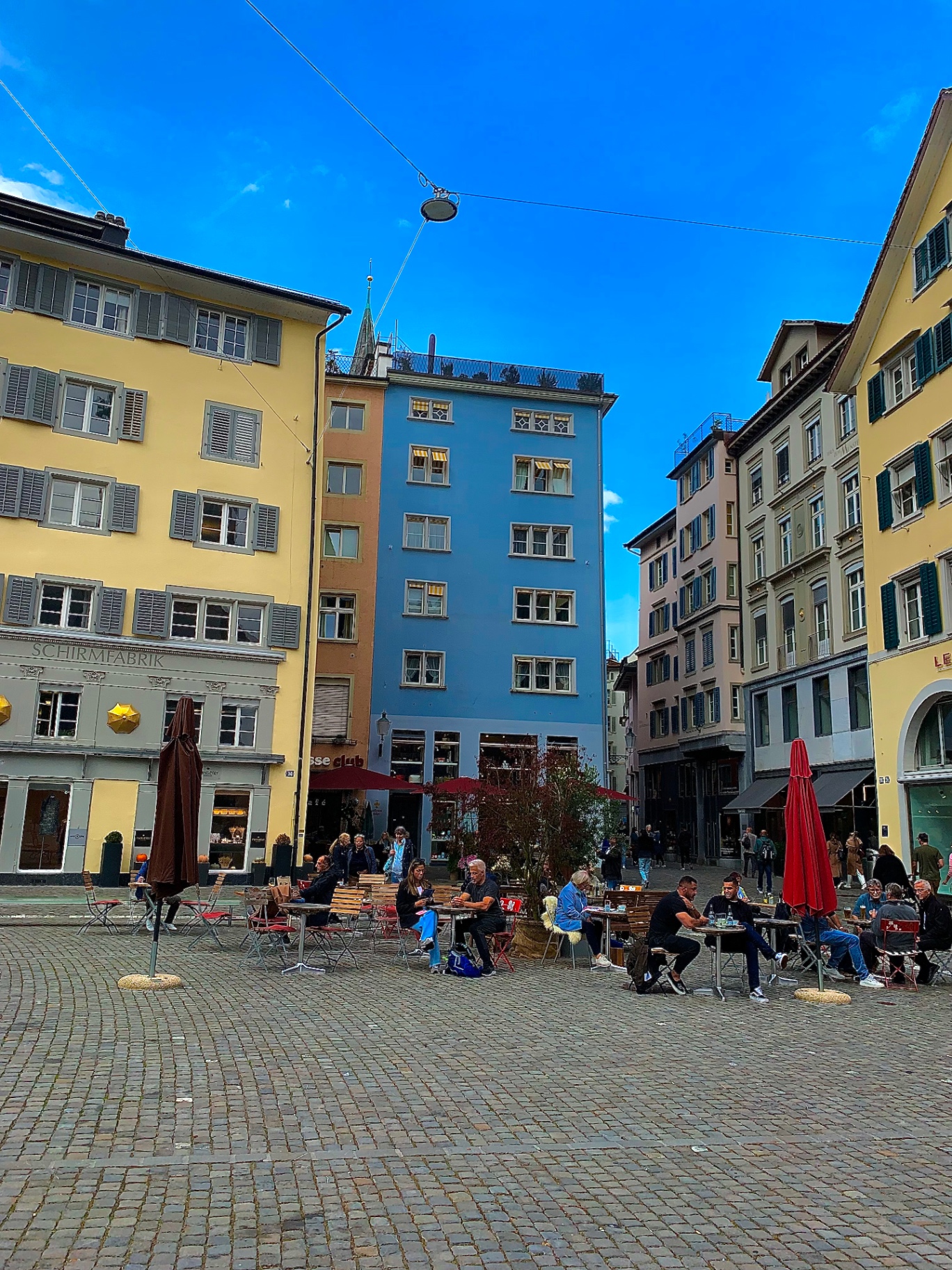 Café tables in a pastel Old Town square